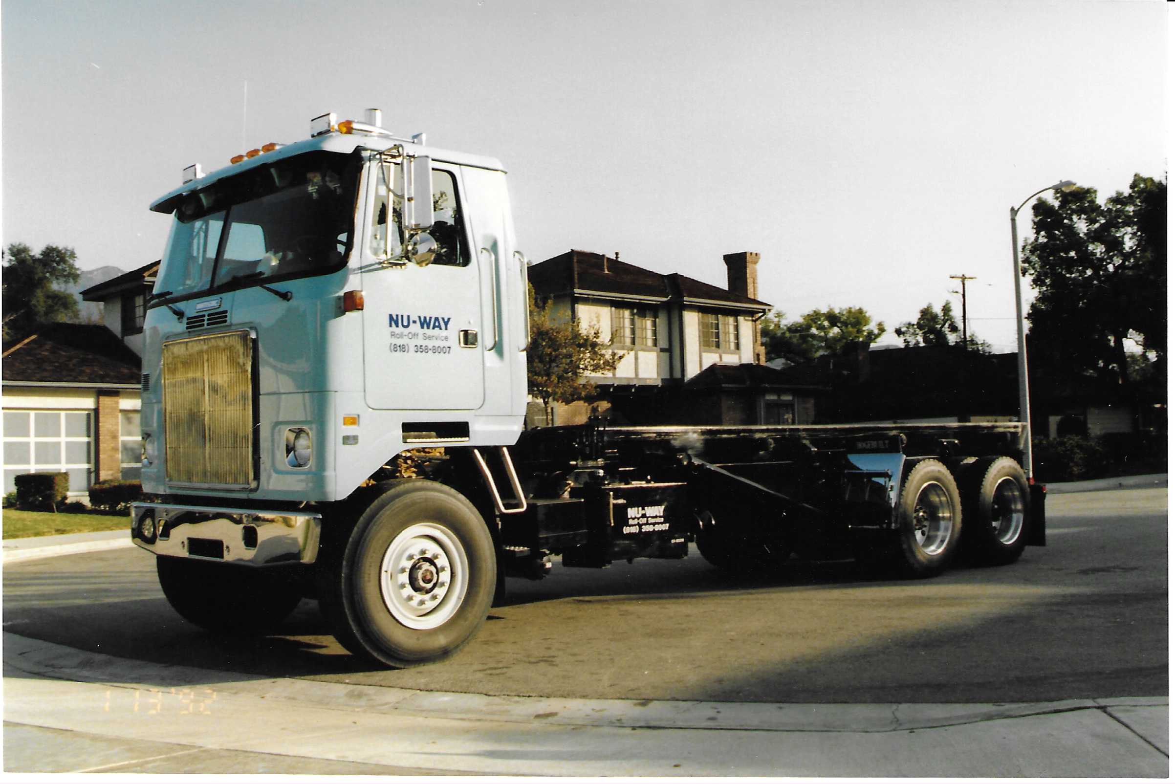 White GMC Roll Off Truck Cab Over